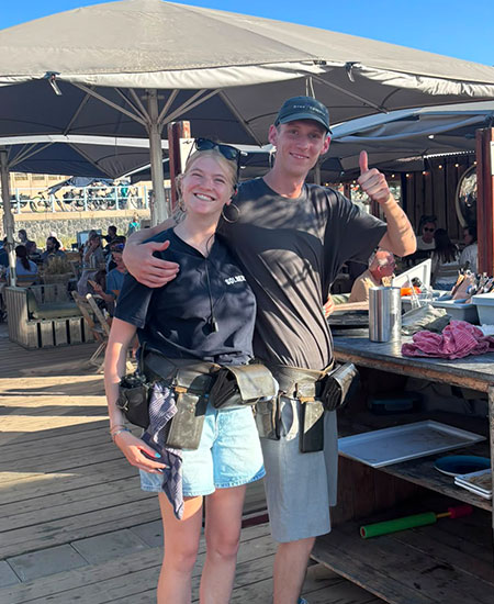 Het horecateam van strandtent Solbeach Scheveningen met uitzicht op zee.