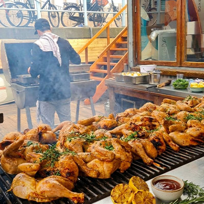 Grote schalen met gemarineerde grillspecialiteiten voor het barbecuebuffet bij Solbeach Scheveningen.